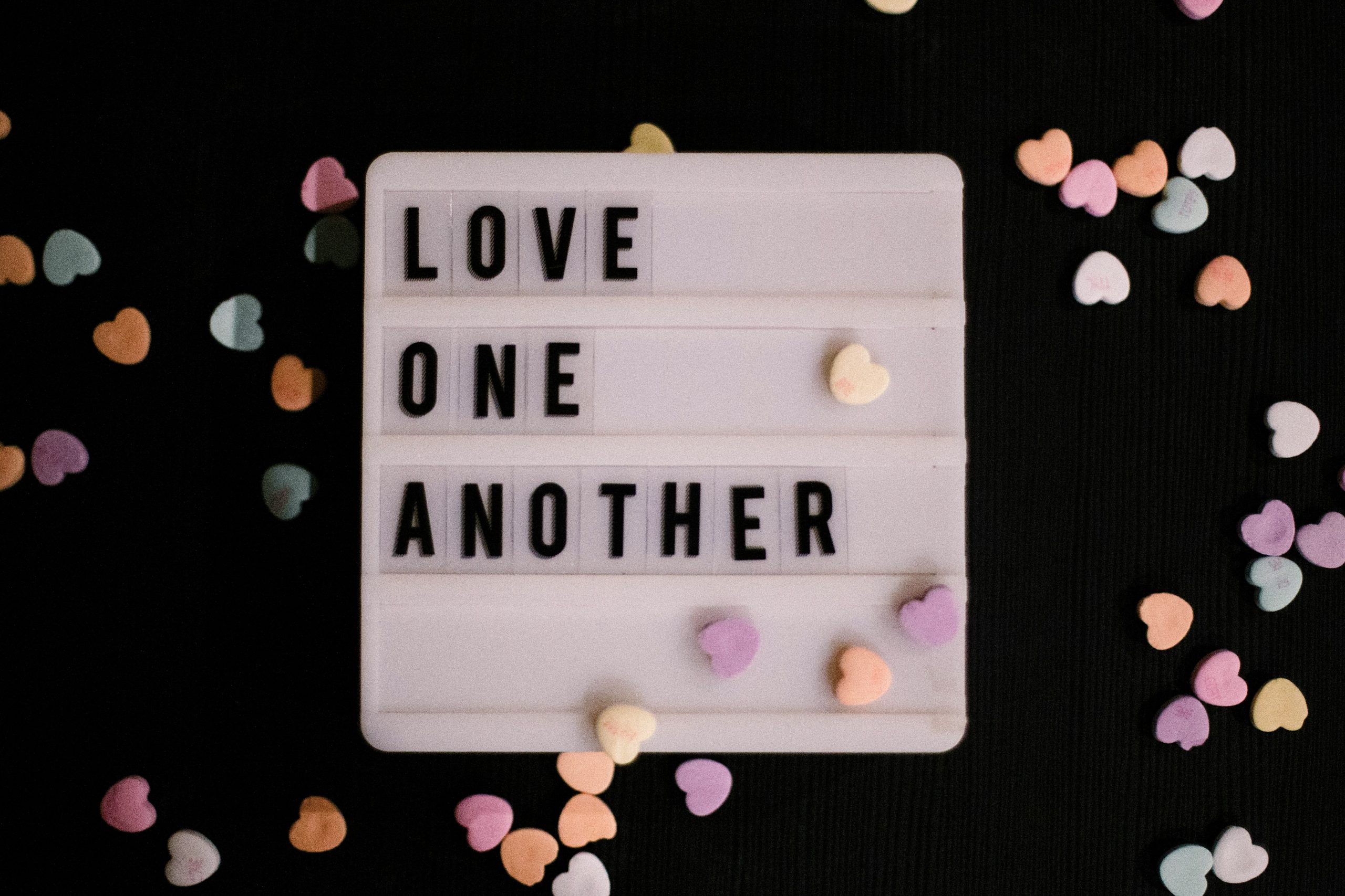 love one another text with hearts